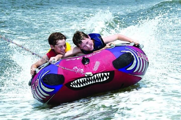 a young girl riding a wave on a surfboard in the water