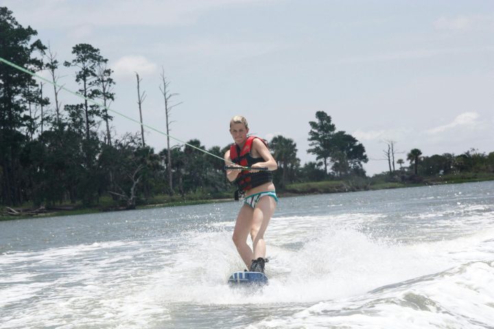 a man water skiing on a lake