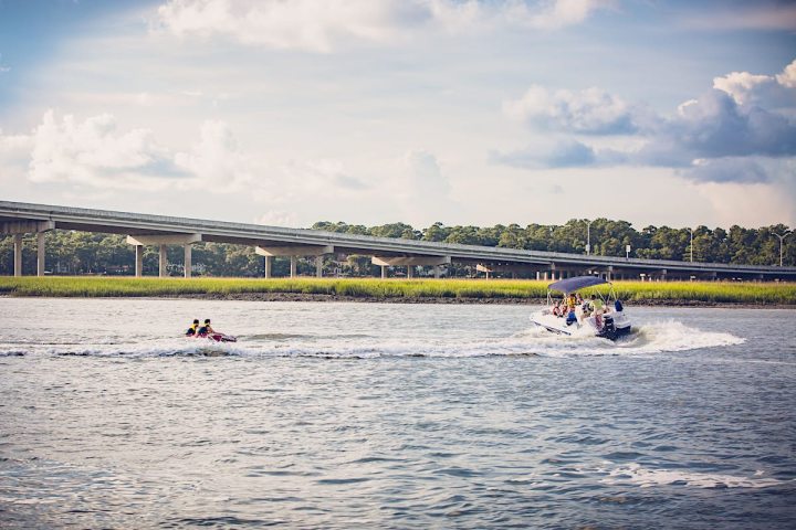 a group of people rowing a boat in a body of water
